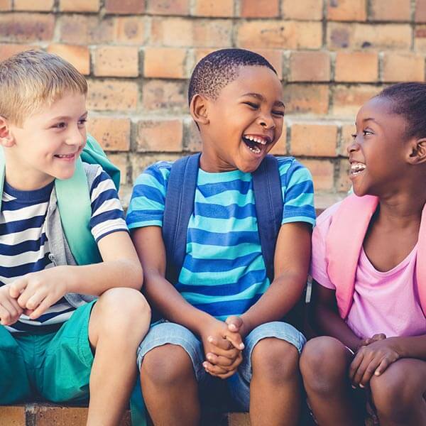 3 Friends sitting on a step, enjoying 