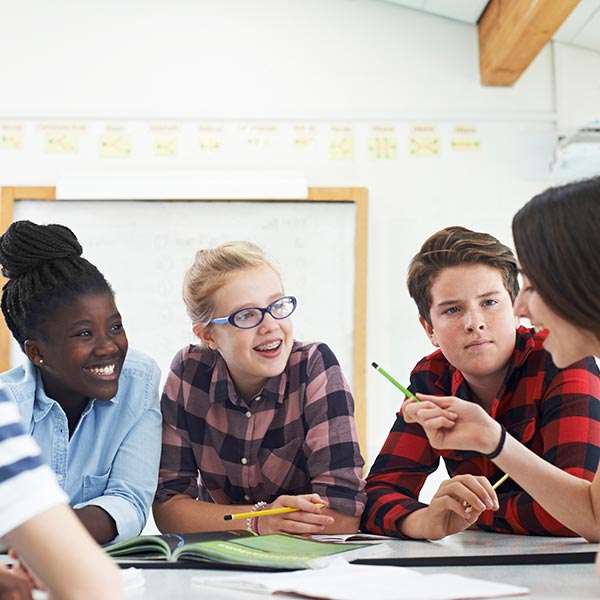 Group of older school students collaborating on a project